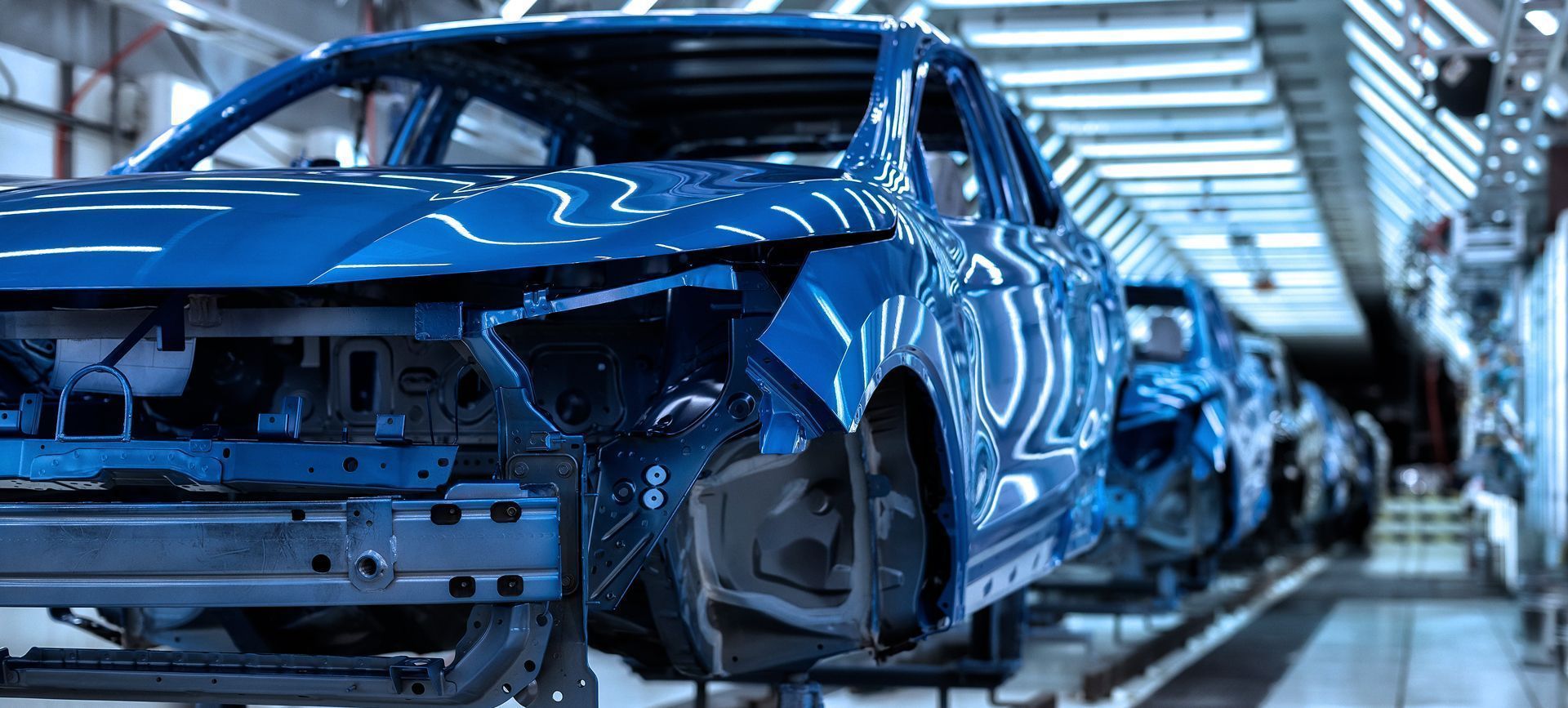 Row of finished car bodies in a production site welded together with laser by Laserline diode lasers