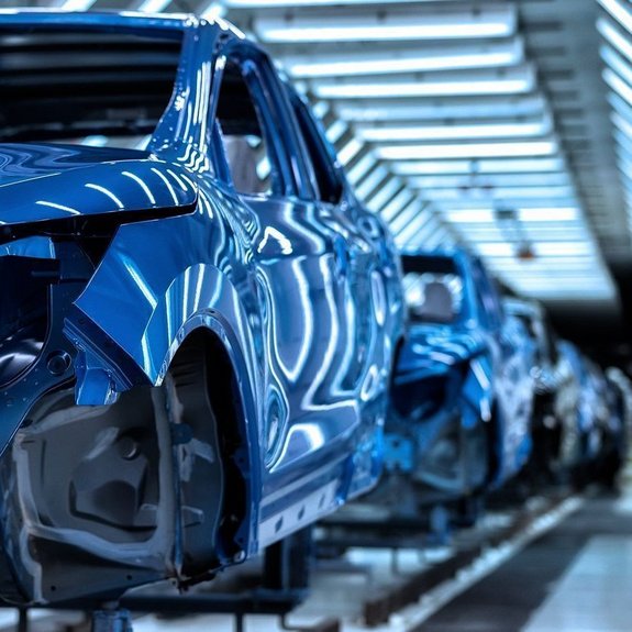 Row of finished car bodies in a production site welded together with laser by Laserline diode lasers