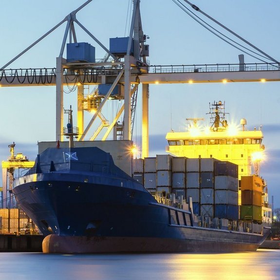 Transportation ship loaded with containers stationed at a port by Laserline diode lasers